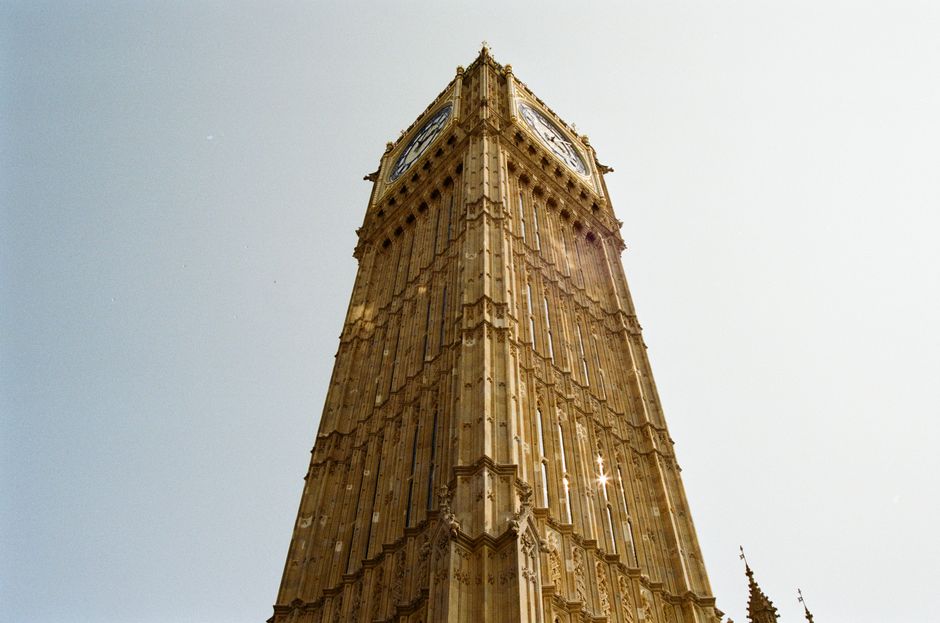 View of Big Ben in London from a low angle on a clear day, showcasing its architectural beauty.