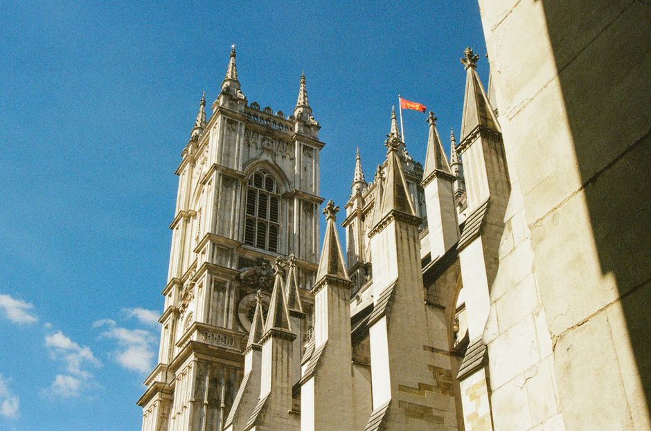 Stunning view of Westminster Abbey's ornate Gothic tower against a clear blue sky.