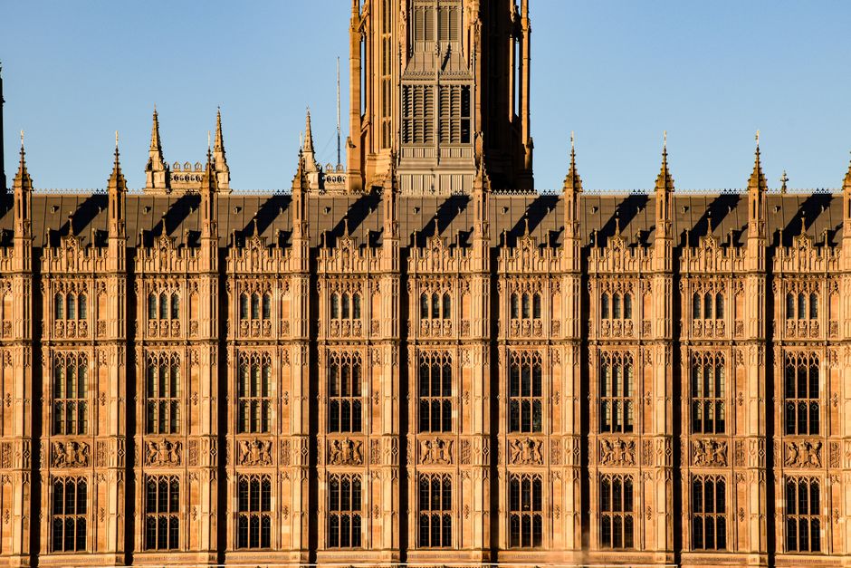 Close-up view of the intricate Gothic Revival facade of the Palace of Westminster in London.